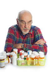 elderly man looking at his meds