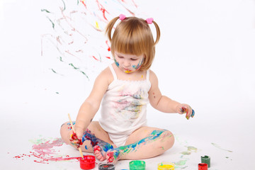 little girl bedaubed with bright colors