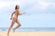 © Andrey_Arkusha - happy woman in bikini walks on a beach