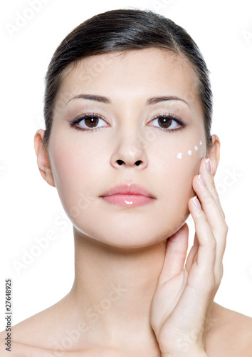 Naklejka nad blat kuchenny adult woman applying cosmetic cream around the eye