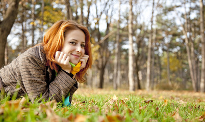 Sticker - Portrait of red-haired girl in the autumn park.