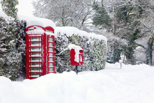 Red Telephone And Post Box In The Snow