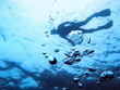 Air bubbles rising to water surface with man snorkeling, natural scene, Mediterranean sea
