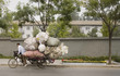 Chinese man on overloaded bike