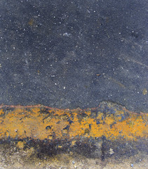 metal and stone surface with orange stripe