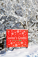 A Sign In The Snow Showing The Way To Santas Grotto
