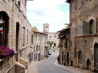 Wall Mural - Medieval street in Assisi, Italy and the church San Pietro