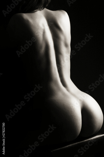 Naklejka na szybę Beautiful ass of young woman over dark background