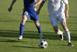 Photo of soccer players with ball in action