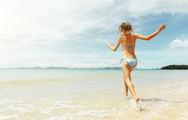 Wall Mural - Young woman on the beach