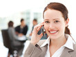 © WavebreakMediaMicro - Attractive businesswoman on the phone while her team is working