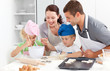 © WavebreakMediaMicro - Happy family cooking a cream together in the kitchen