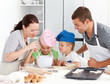 © WavebreakMediaMicro - Adorable family baking together in the kitchen