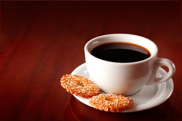 cup of coffee on saucer with cakes