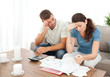 © WavebreakMediaMicro - Worried couple doing their accounts in the living room