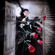 Man killer with gun and red roses