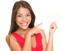 Beautiful Smiling Woman Pointing At Blank Gift Card Sign