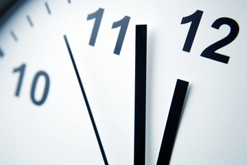 Wall Mural - Close-up of hands on clock face. Midday