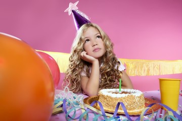 Wall Mural - bored little blond girl birthday party with candle cake