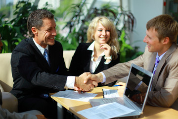 Wall Mural - Business people shaking hands, finishing up a meeting