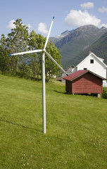 Wall Mural - Small decorative windmill in rural summer landscape.