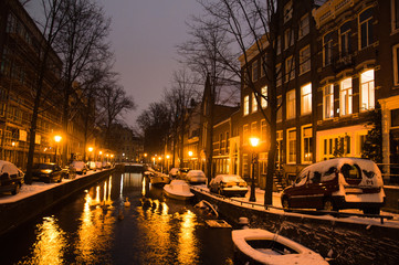 Amsterdam canals and typical houses on a snowy winters night