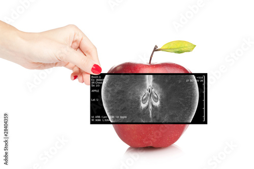Fotografie, Obraz Female doctor holding an x-ray revealing inner view of a red app