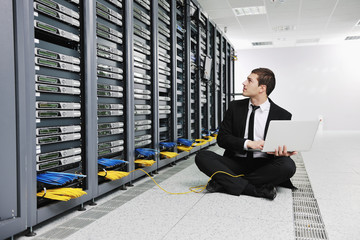 Wall Mural - businessman with laptop in network server room