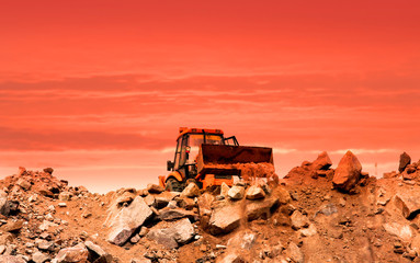 Earth moving equipment at work with evening sky background