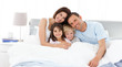 © WavebreakMediaMicro - Happy children with their parents on the bed