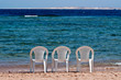 Three chairs on the beach