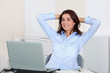 © goodluz - Businesswoman with stretched arms in office