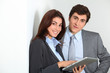 © goodluz - Business people using electronic tab