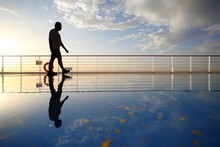 Silhouette Of Old Man Walking Throught Deck Of Cruise Ship