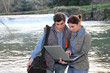 © goodluz - Biologists testing water of natural river