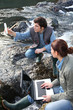 © goodluz - Biologists testing water of natural river