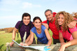 © goodluz - Group of friends hiking in countryside