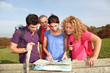 © goodluz - Group of friends hiking in countryside