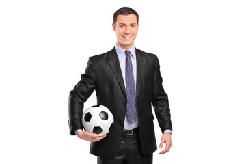 Canvas Print - Smiling businessman holding a football