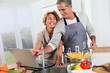 © goodluz - Couple in kitchen looking at recipe on internet