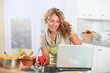 © goodluz - Beautiful blond woman looking at recipe on internet
