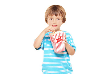 Portrait of a young boy eating popcorn