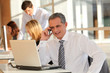 © goodluz - Businessman in the office talking on the phone