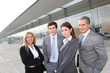 © goodluz - Group of business people standing outside building