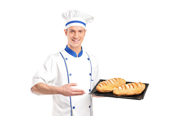 Smiling baker showing freshly baked breads