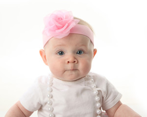 Close up portrait of pretty baby wearing pearls