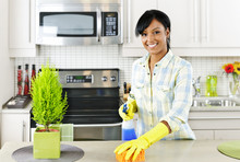 Young Woman Cleaning Kitchen