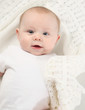 © blessings - closeup portrait of adorable baby lying on a white blanket