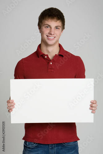 Fotografering Attractive teenage boy holding a blank sign