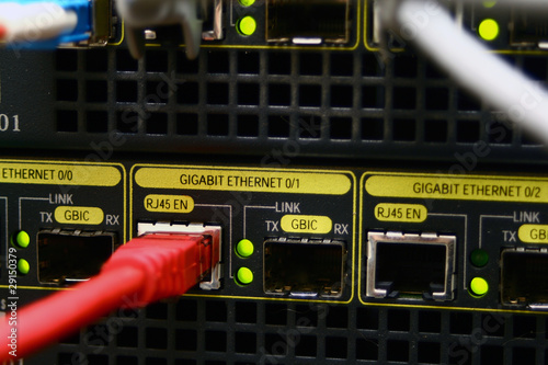 Fotografie, Obraz Red ethernet cable connected at gigabit speed